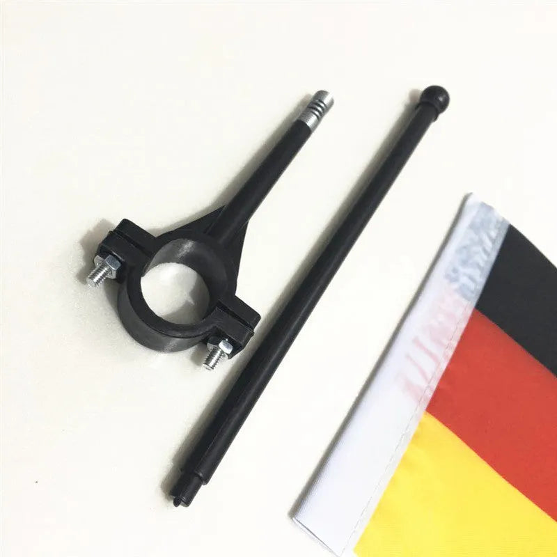 Square polyester cycling flag on a plastic pole mounted on a bicycle handlebar.