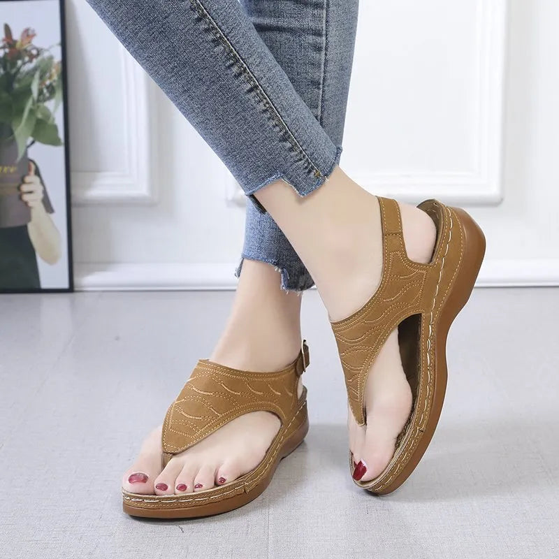 Women's black casual wedge heel sandals with an adjustable buckle strap on ankle.