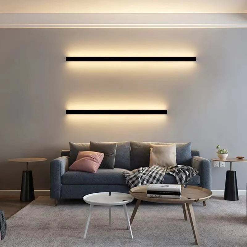 Black 80cm long aluminium LED strip wall lamp mounted on a white wall.