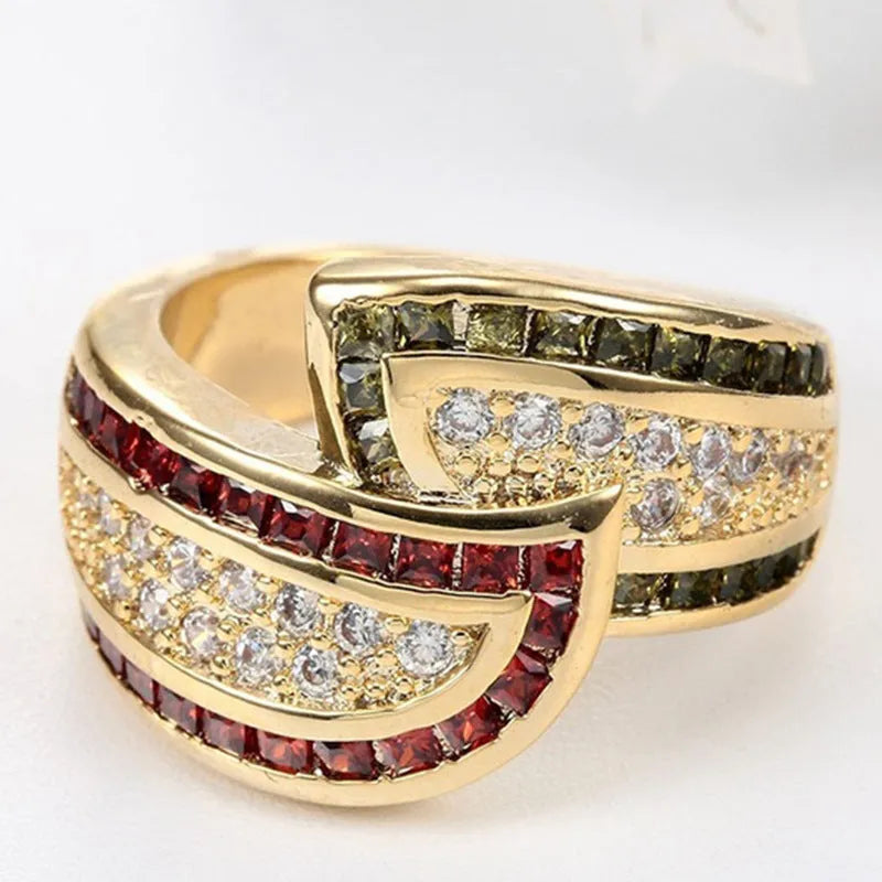 Gold tone alloy women's ring with a central peridot green stone.