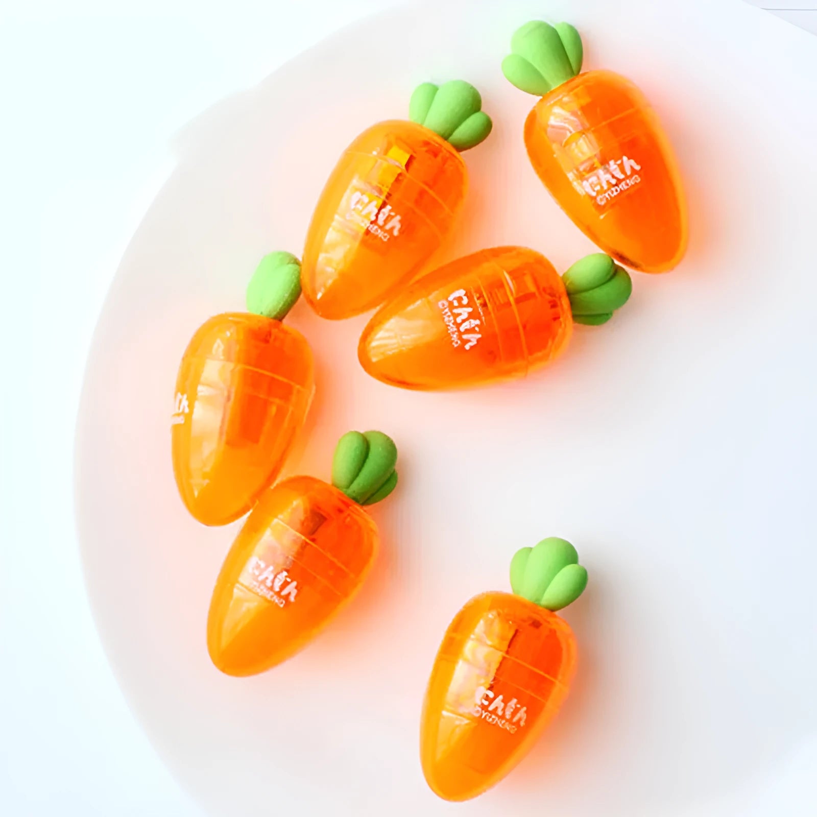 Orange carrot-shaped plastic pencil sharpener with 7cm handle length