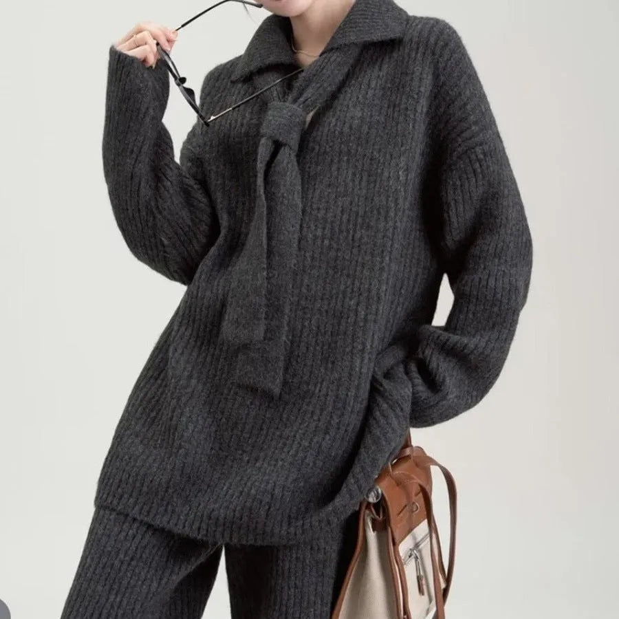 A dark grey sweater suit two-piece set featuring a long-sleeved knit top and matching casual trousers.
