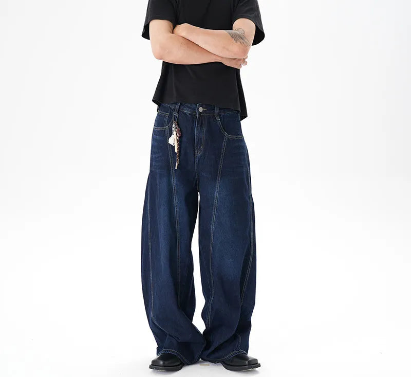 Dark blue wide-leg jeans with a distressed wash on a denim fabric, showing a relaxed fit.