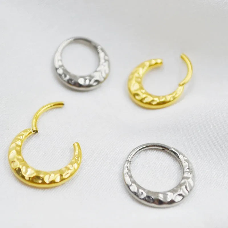 Titanium alloy ASTM F136 concave-convex nose ring in gold and silver colour options showing textured surface detail