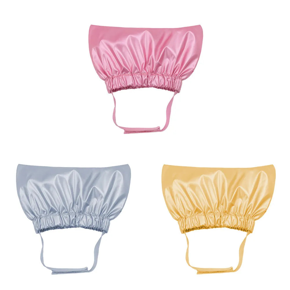 Pet shower cap in silver colour showing adjustable ear coverage and waterproof non-woven fabric construction