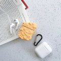 Green silicone AirPods 1/2 generation case with a cartoon animal design on a table.