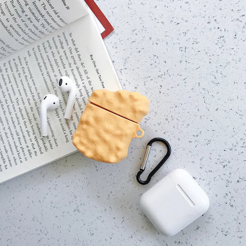Green silicone AirPods 1/2 generation case with a cartoon animal design on a table.