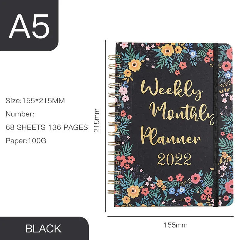 A5 spiral notebook with colourful floral cover, open to show lined pages and metal coil binding
