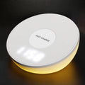 White wireless charging pad with clock display and control buttons for smartphone charging
