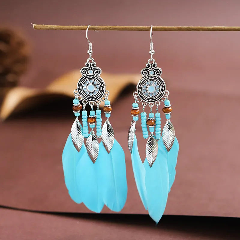 Round drop feather earrings in alloy with electroplated finish showing leaf shape and pattern details