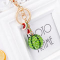 Green zinc alloy watermelon-shaped keychain on a white background.