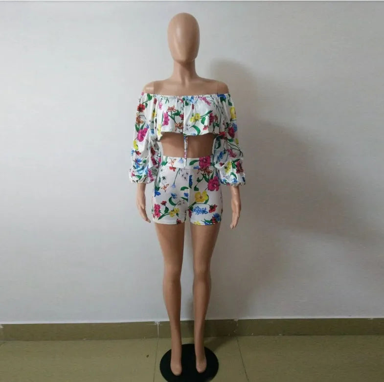 Women's multicolour printed tracksuit set with fleece sleeves on the top and matching shorts.