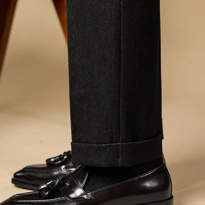 Men's black polished leather tassel loafers with rubber soles for business casual wear
