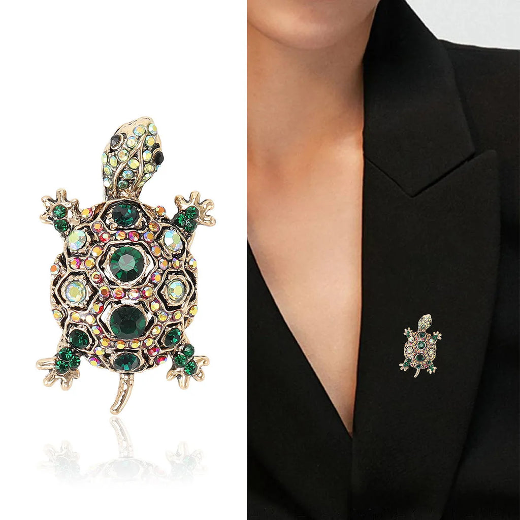Close-up of a retro-style rhinestone turtle brooch in alloy, shown in blue, green and red colour options.