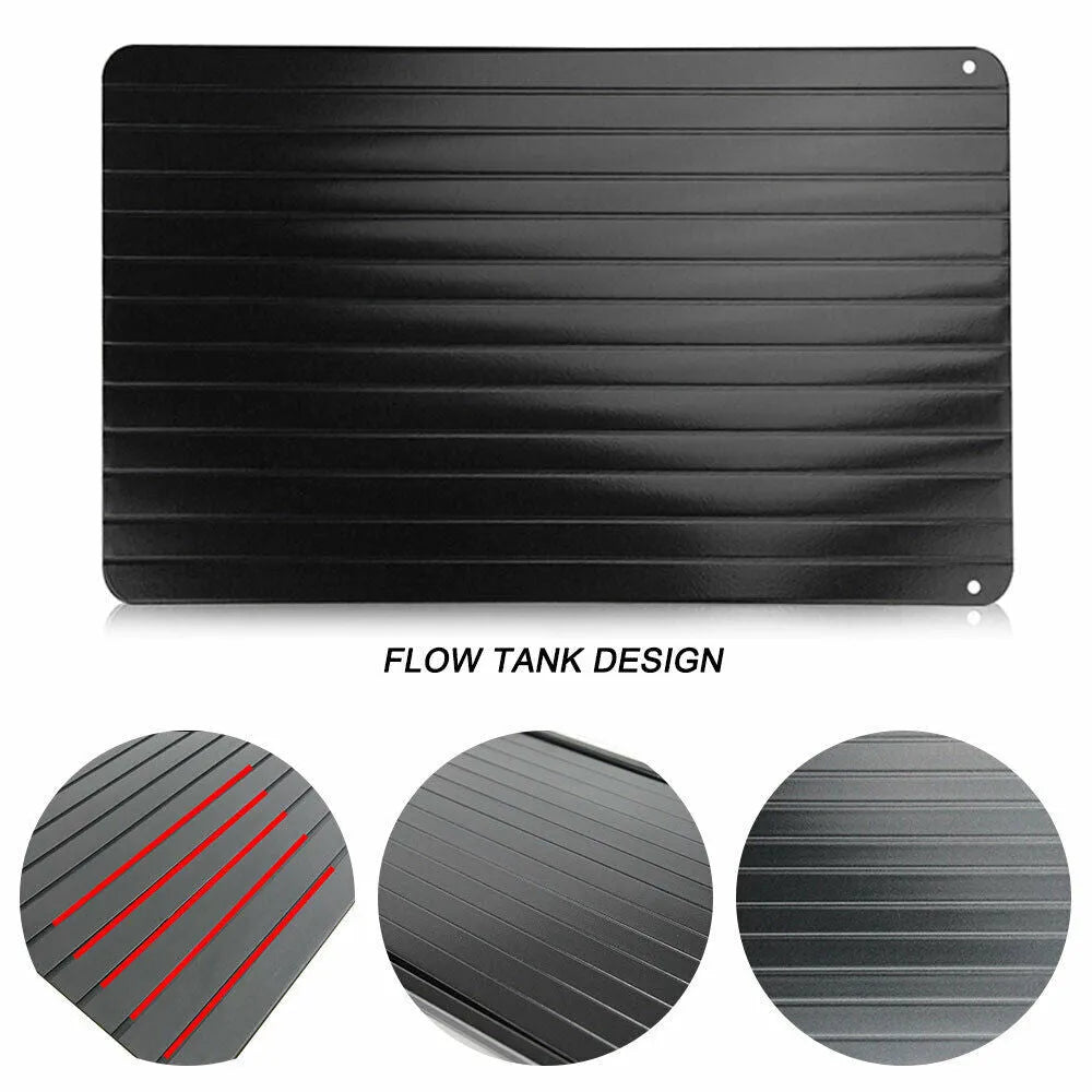 Black rectangular aluminium fast defrost tray for thawing frozen food on a kitchen counter.
