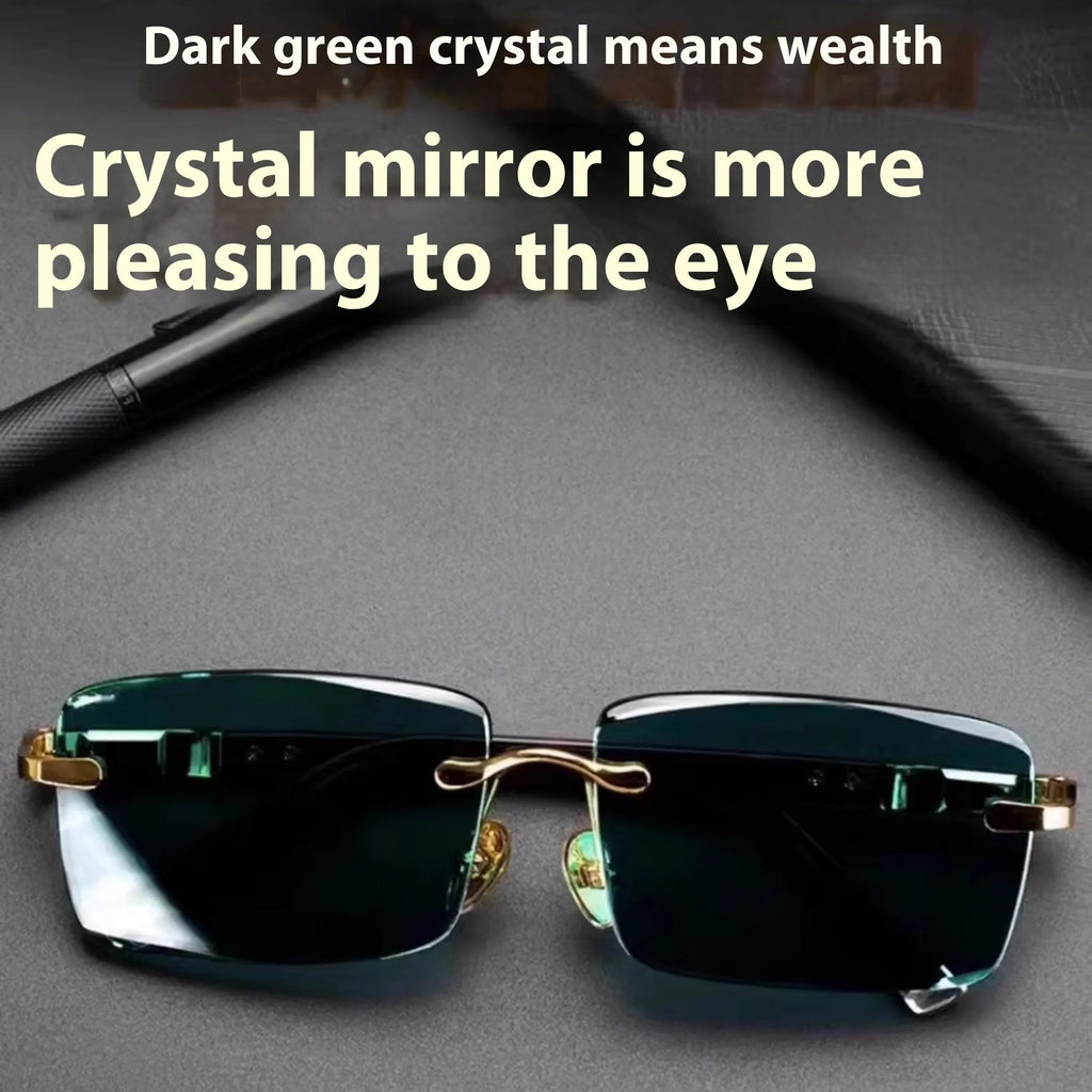 Dark green frameless crystal sunglasses with a hard case and cleaning cloth on a plain background.
