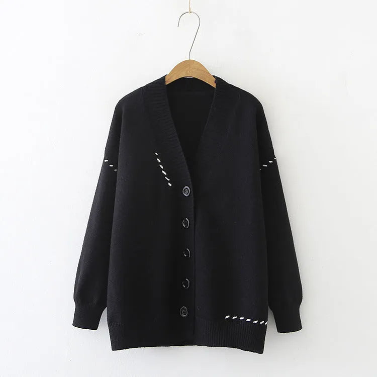 Women's loose-fit black knitted cardigan top coat with long sleeves on a hanger.