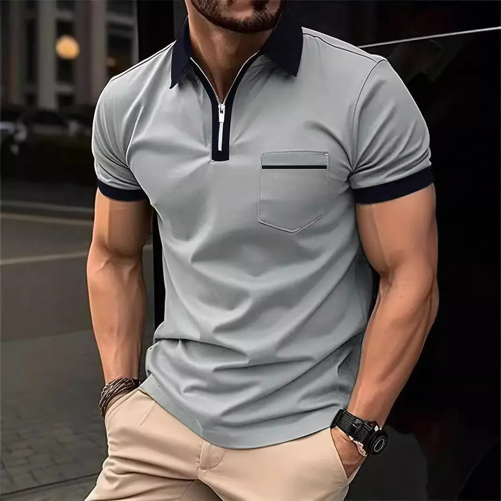Man wearing a loose-fit short sleeve casual shirt with a chest pocket and zipper detail.