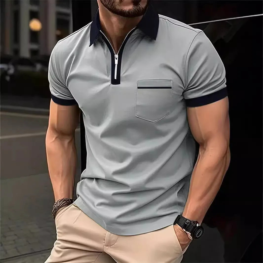 Man wearing a loose-fit short sleeve casual shirt with a chest pocket and zipper detail.