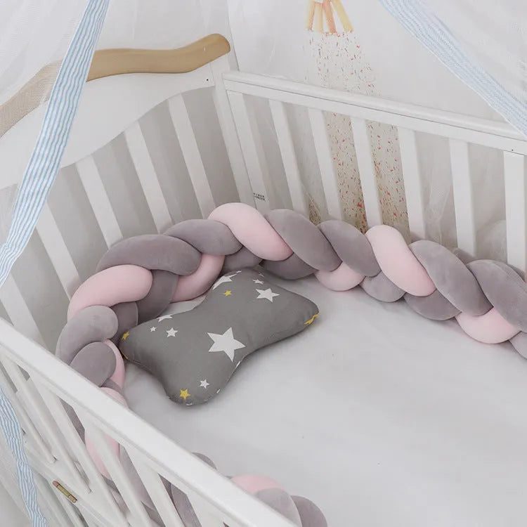 Baby crib bumper protector in spandex velvet, bent to show flexible shape, against a crib rail.
