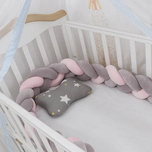 Baby crib bumper protector in spandex velvet, bent to show flexible shape, against a crib rail.