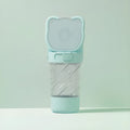 Green 3-in-1 portable pet water bottle with attached bowl, food container, and waste bag dispenser.