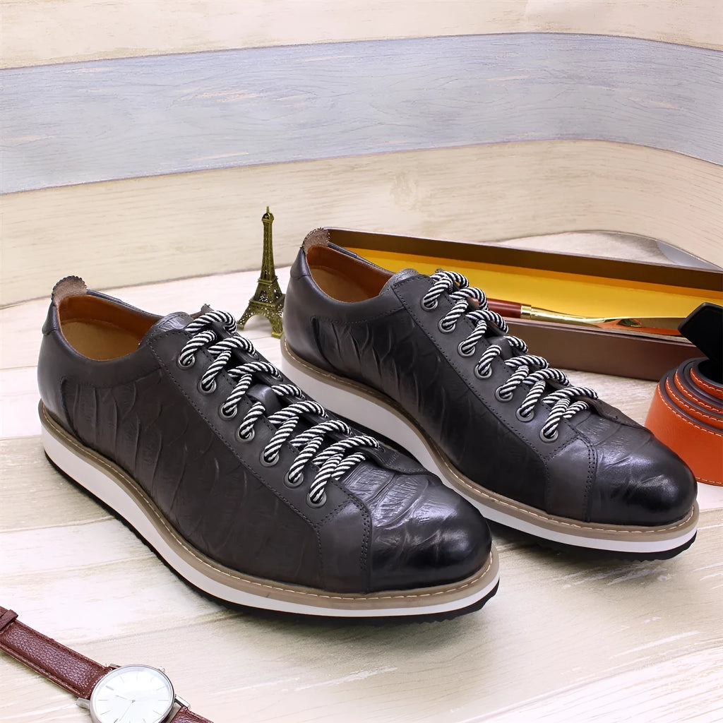 Men's low-top handmade shoes with an embossed pattern and front tie laces.