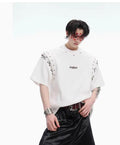 Women's black short sleeve t-shirt with white lace-up cutout detail on front.