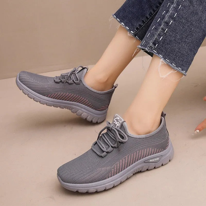 Women's mesh breathable casual sneakers in black with cross strap design and round toe