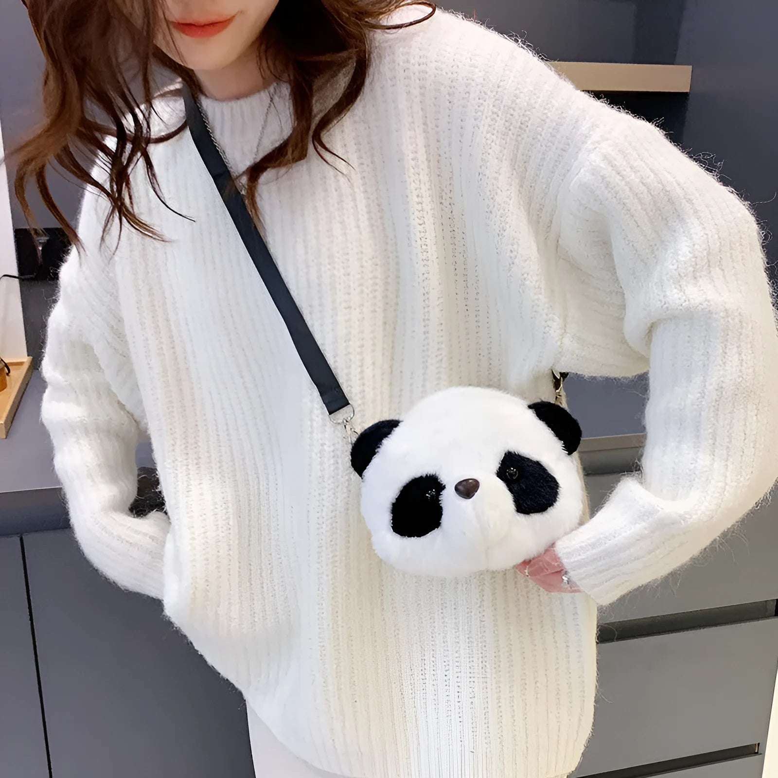 Soft plush crossbody bag with panda head design, shown in cylindrical shape.