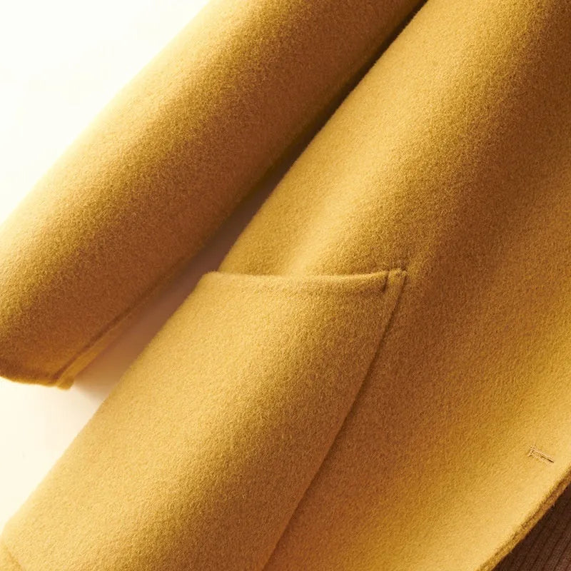 Women's mid-length wool coat with pearl buckle fastening and doll collar in solid colour