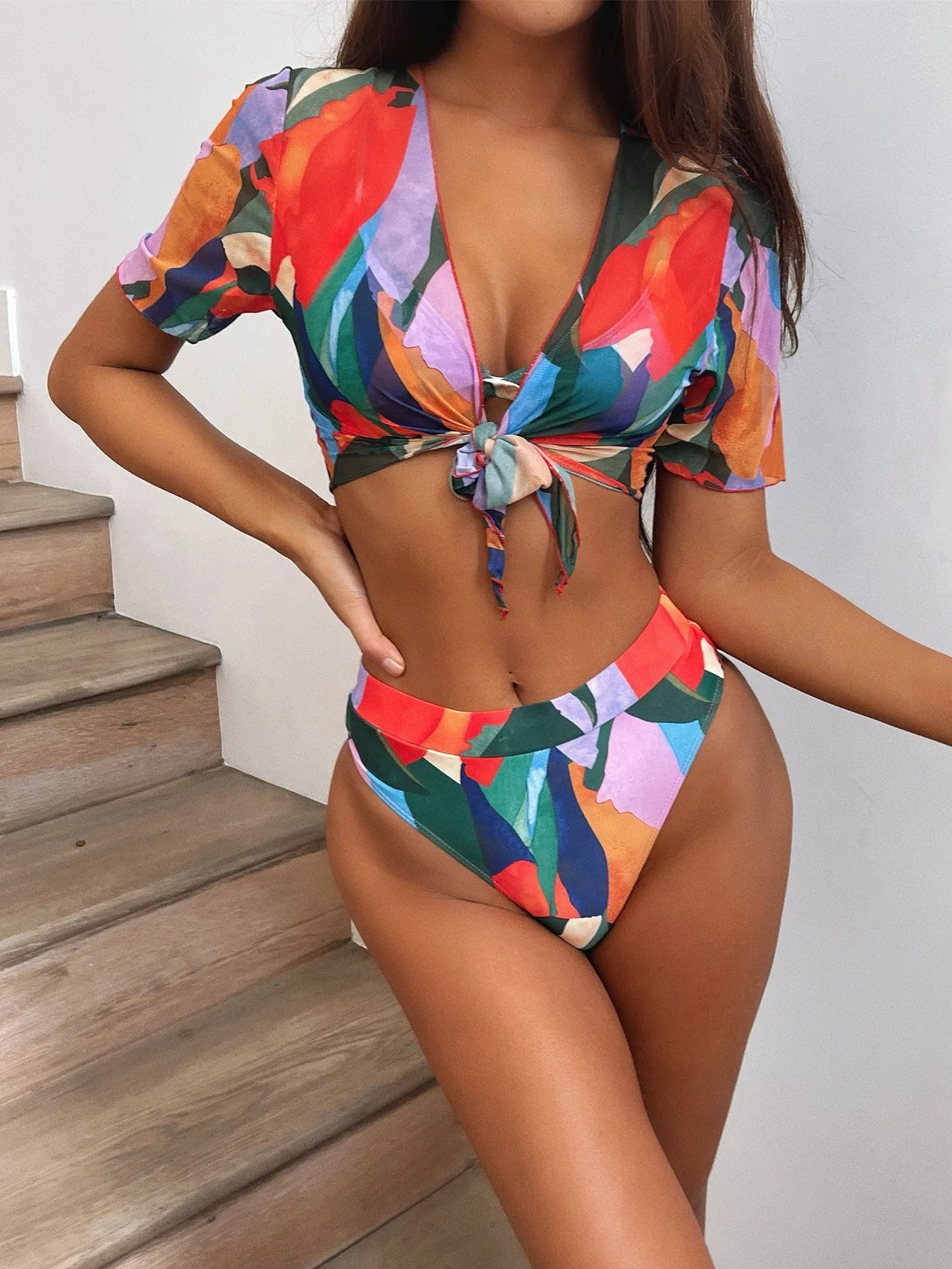 Red printed women's split swimsuit bikini on a mannequin.