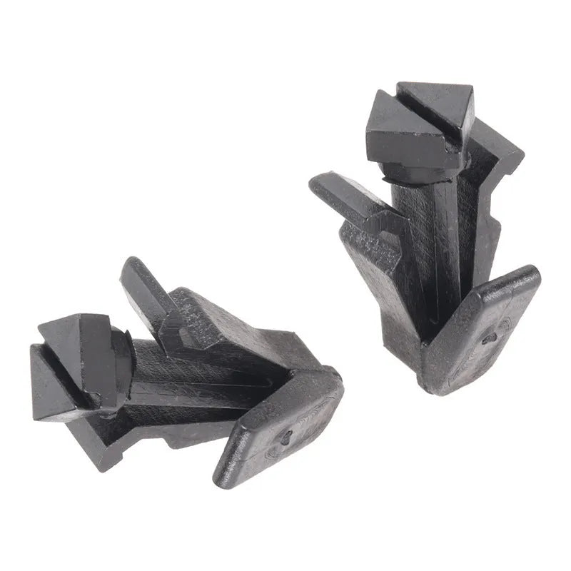 Black plastic automotive fastening clip for Nissan bumper or grille, part number 76882-0M060.