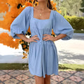 Orange children's backless dress with a square collar and puff sleeves, showing A-line skirt.