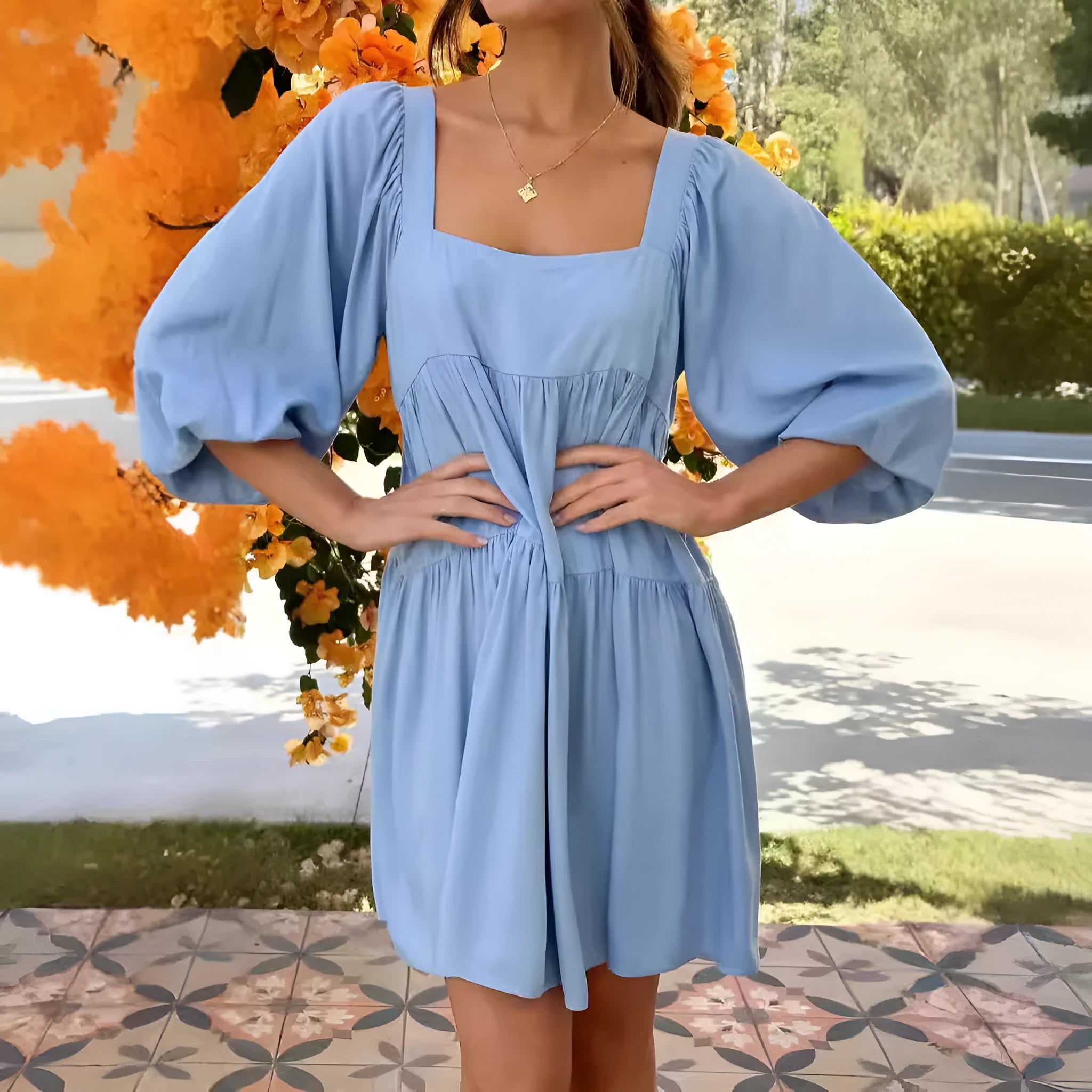 Orange children's backless dress with a square collar and puff sleeves, showing A-line skirt.