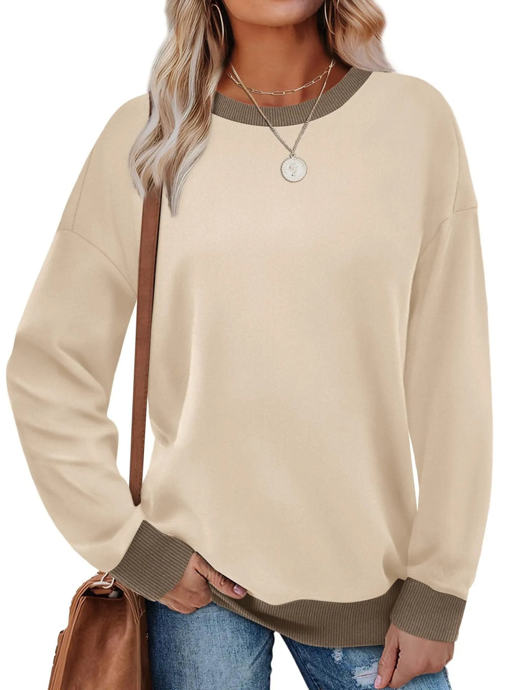 Women's loose striped long-sleeved top in polyester showing round neck and regular sleeve construction