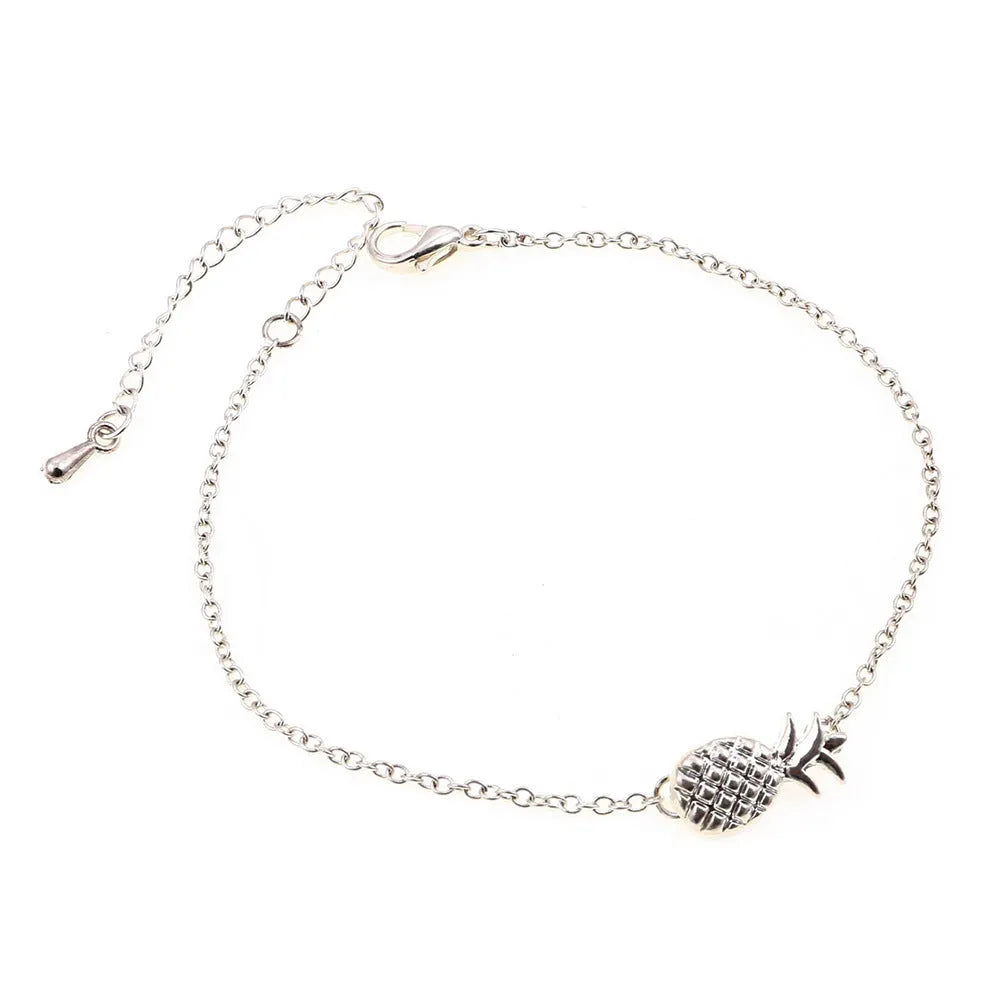 Close-up of a women's alloy bracelet featuring a detailed pineapple charm in gold or silver colour.