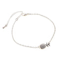 Close-up of a women's alloy bracelet featuring a detailed pineapple charm in gold or silver colour.