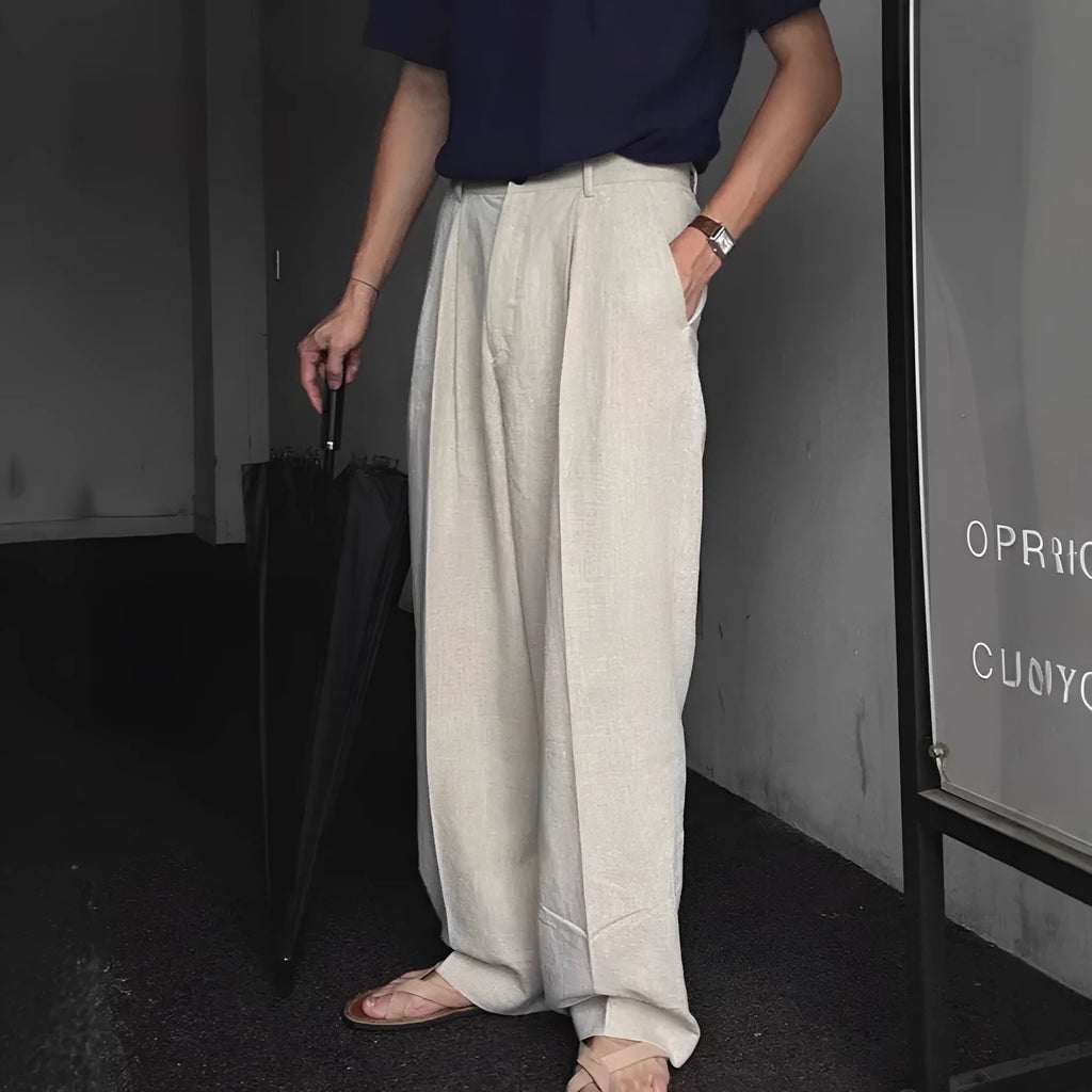 Men's loose-fit apricot cotton linen trousers with a mid-waist and pencil leg opening.