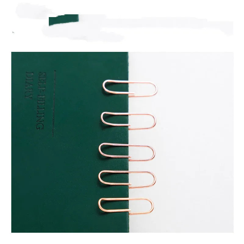 Rose gold heart-shaped metal paper clips measuring 28mm with steel core construction