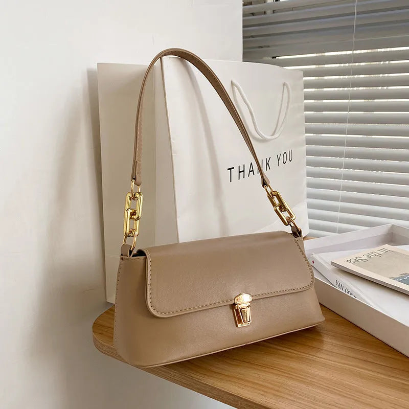 Brown French casual underarm bag with single shoulder chain strap and sandwich pocket design
