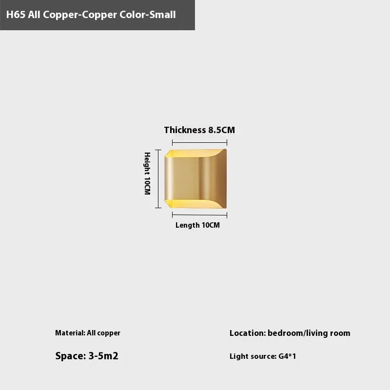 Minimalist copper wall lamp in black gold finish mounted beside a bed