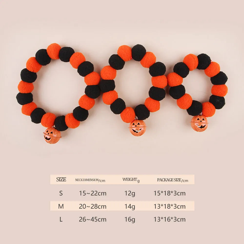 Orange Halloween cat collar with plastic pumpkin, ghost, and bat charms on a black strap.
