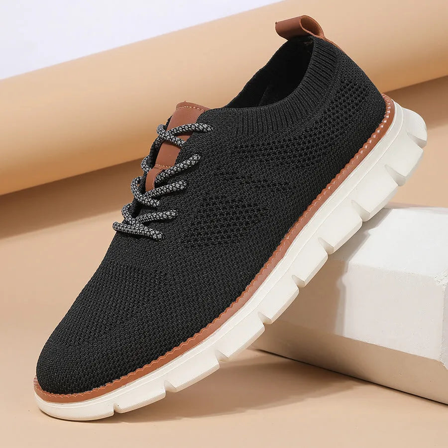 Men's grey and black low-top casual sneakers with woven mesh fabric upper and round toe.