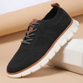 Men's grey and black low-top casual sneakers with woven mesh fabric upper and round toe.