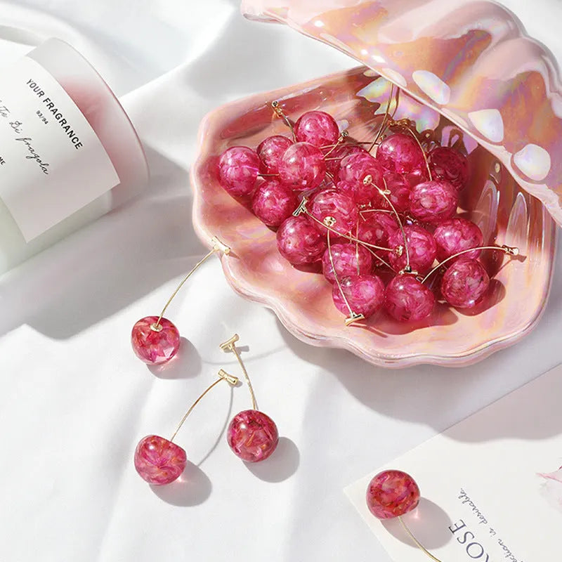 Long red French dried cherry earrings for women in plated alloy design on white background