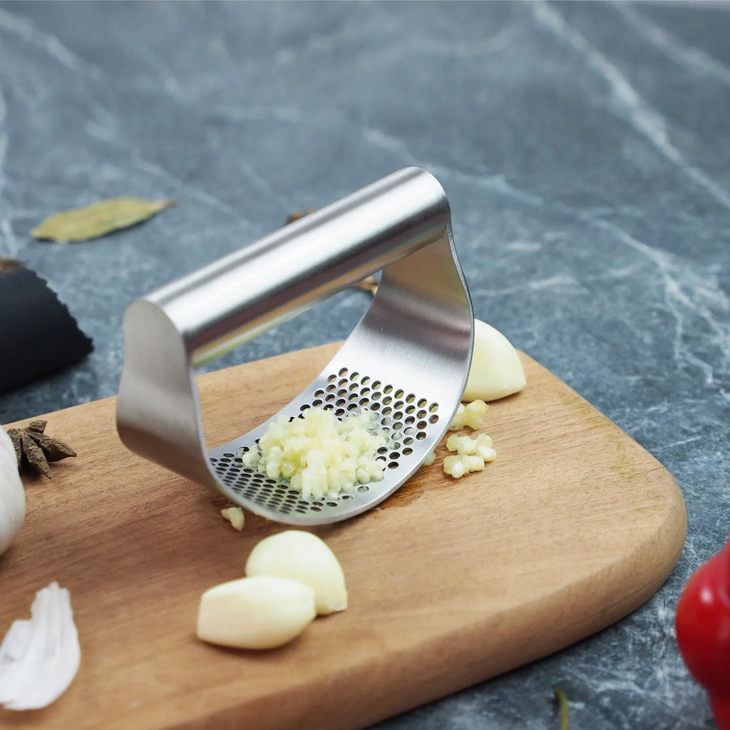 Stainless steel onion fork kitchen tool with a PP handle and fine pressing holes.