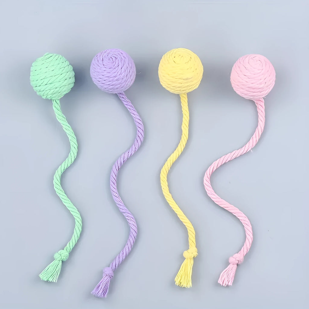 Colourful cat toy ball with an attached rope and built-in bell for kittens, shown in green, pink, purple, and yellow.