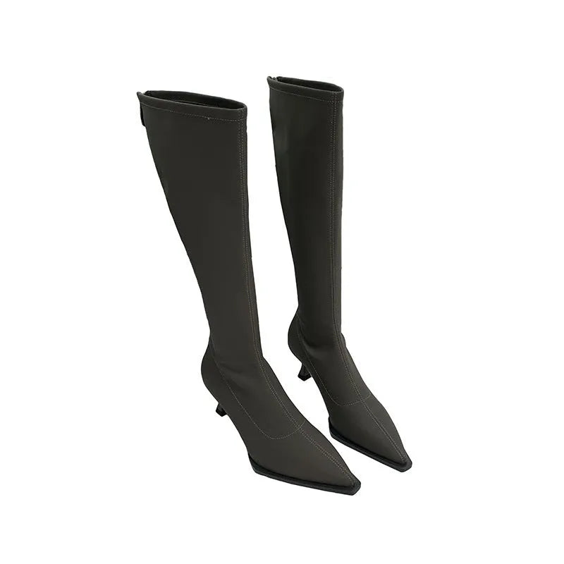 Black pointed toe women's boots with stiletto heel and back zipper, shown from the side.