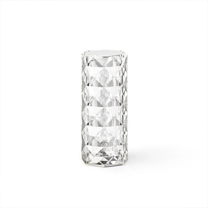 Creative acrylic crystal rose LED table lamp with adjustable three-colour lighting on a wooden surface.